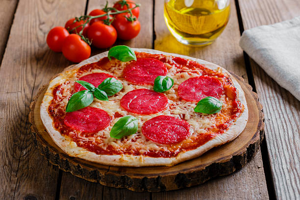istock pizza with salami round on a wooden surface 537097473