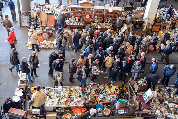 Barcelona, Spain - March 12, 2014: The most famous flea market in Barcelona, also known as Els Encants or Els Encants Vells, located in Glories neighborhood. Customers choosing and looking for something interesting.