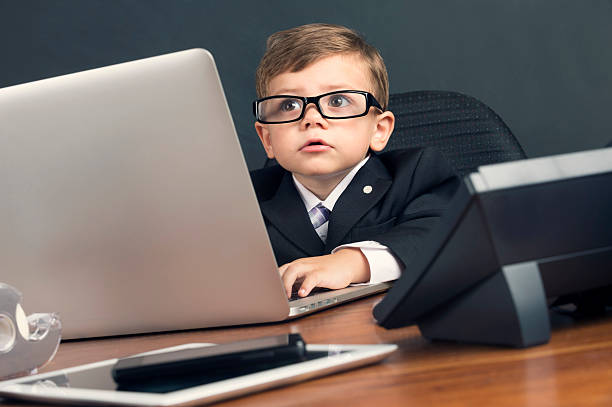 istock Humorous image of a young boy working on a laptop 537099685