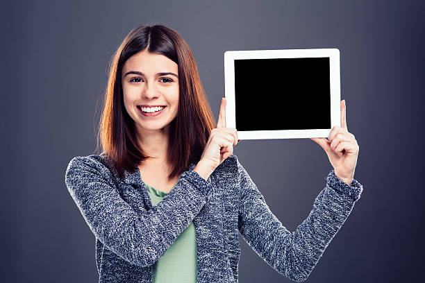 istock Young girl holding tablet 537100675