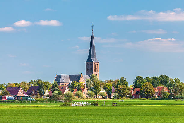 Small Dutch village in the province of Friesland Small Dutch village with church in the province of Friesland friesland netherlands stock pictures, royalty-free photos & images