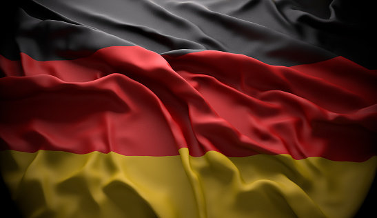 Germany, Berlin official national state flag in black ambience with light coming from the top