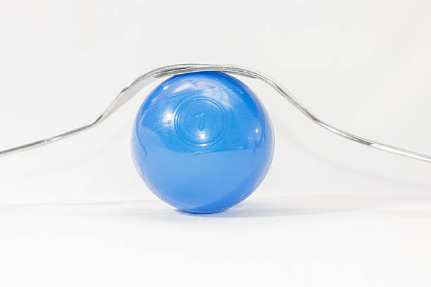 istock two forks and colored balls on a white background 537115449
