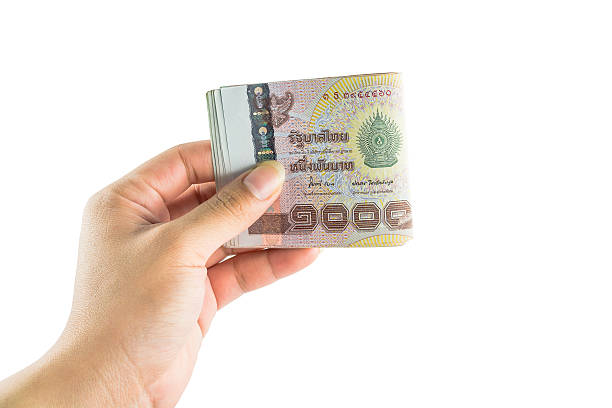 istock Hand holding Thai banknotes, isolated on white background 537116439