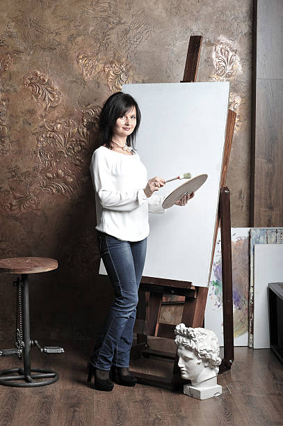 istock girl painting on the easel 537116975