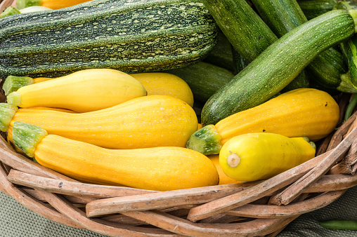 Yellow and green squash on display in baskets