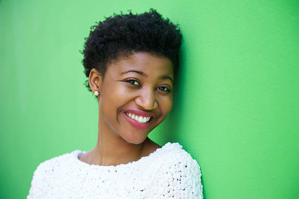 istock Cute young woman smiling on green background 537118499