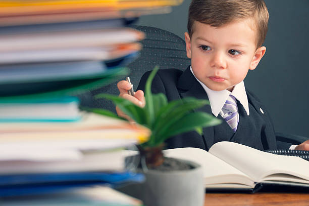 istock Humorous business manager concept. Young child in a suit working 537120047