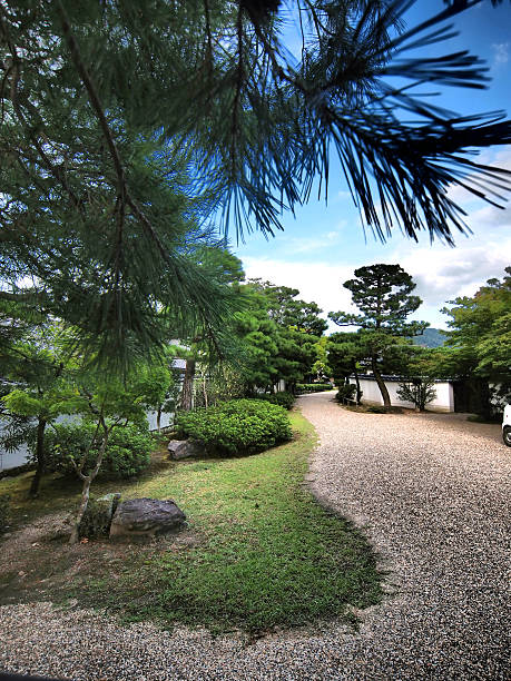 Street arrangement with stones, trees and grass between the houses in old Kyoto, which is old Japanese capital and famous tourist destination with a lot of temples and history. It is E5 build in camera HDR filte.