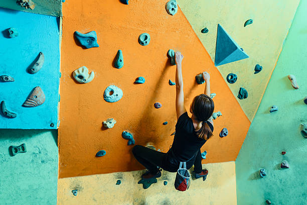 istock Woman climbing up on wall indoors 537120783