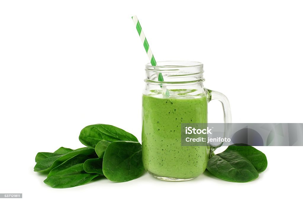 Green smoothie with spinach isolated Healthy green smoothie with spinach in a jar mug isolated on white Smoothie Stock Photo