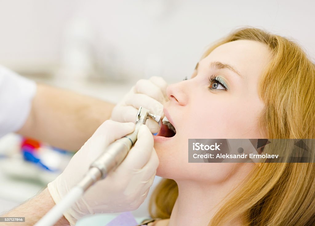 medical dentist procedure of teeth polishing close-up medical dentist procedure of teeth polishing with cleaning from dental deposit Brushing Teeth Stock Photo