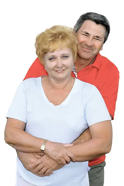 Elderly couple embrace each other . Isolated over white.