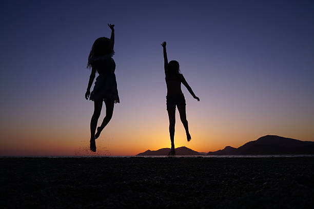 istock Young girls jumping on the beach. 537148034