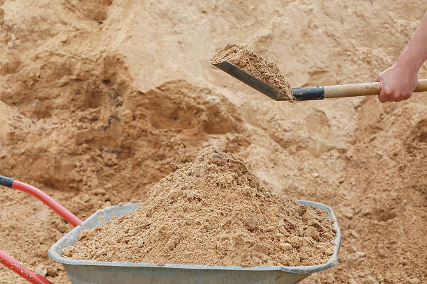 istock Construction wheelbarrow filled with sand a shovel 537159978