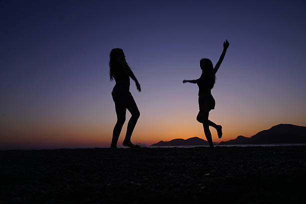 istock Young girls dancing on the beach. 537162462