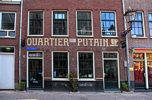 Amsterdam, Netherlands - May 5, 2016:  Quartier Putain cafe in Amsterdam's red lights district near Oude Kerk(Old Church) in Amsterdam, Netherlands.