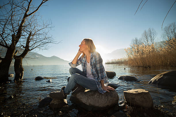istock Day dreaming woman by the lake 537176663