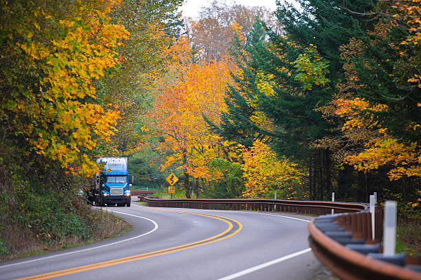 istock Blue truck on spectacular winding autemn highway 537176875