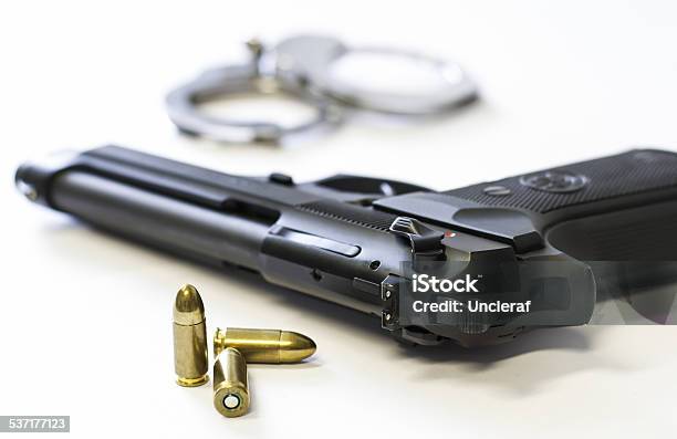 Gun Bullets And Handcuffs On White Background Stock Photo - Download Image Now - 2015, Ammunition, Angung Rai Museum of Art