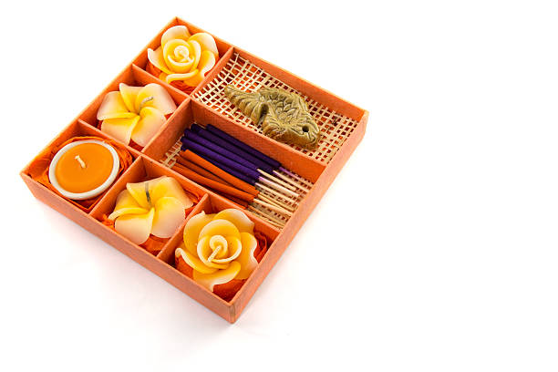Spa Set. Roses Shaped Candles, incense sticks in orange box on white background