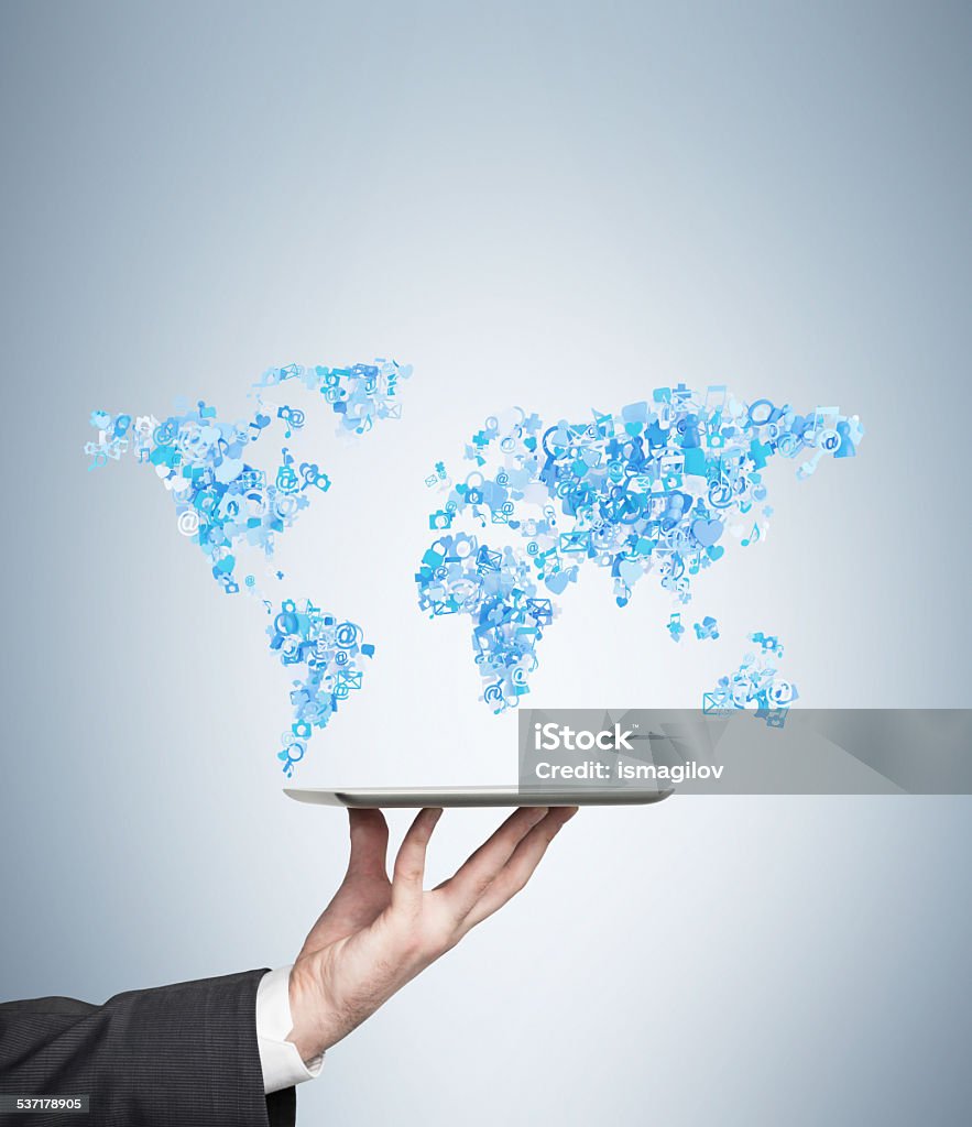 tablet with world map hand holding tablet with social media icon set in form world map 2015 Stock Photo