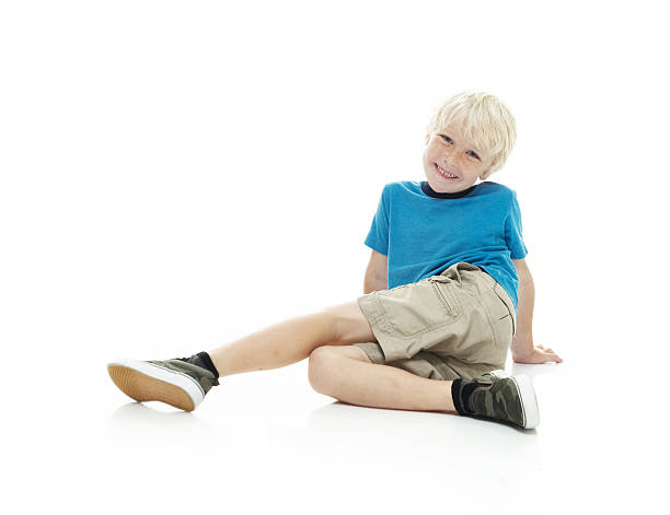 istock Smiling little boy sitting on floor 537182048