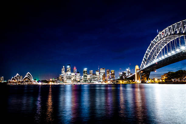 Sydney Harbour bridge at night Classic shot of Sydney Harbour bridge, illuminated at night. sydney harbor photos stock pictures, royalty-free photos & images