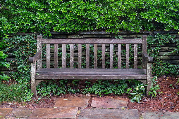 istock Aged Wooden Park Bench on Flag Stone 537182228