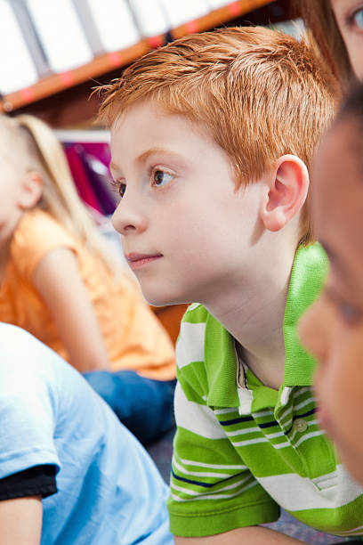 istock Cute little boy listens during story time 537182776