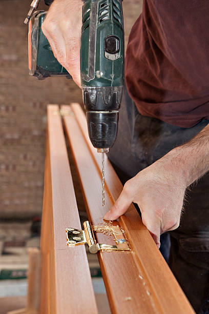 istock Install brass hinges wooden interior door,  carpenter drilled hole, close-up. 537183464