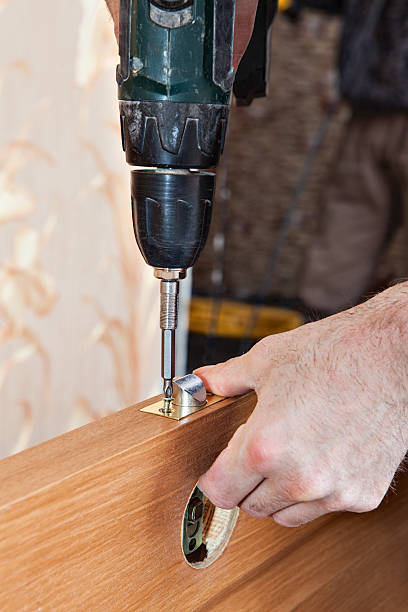 istock Locksmith fixing latch and lock knob wood interior door. 537184244