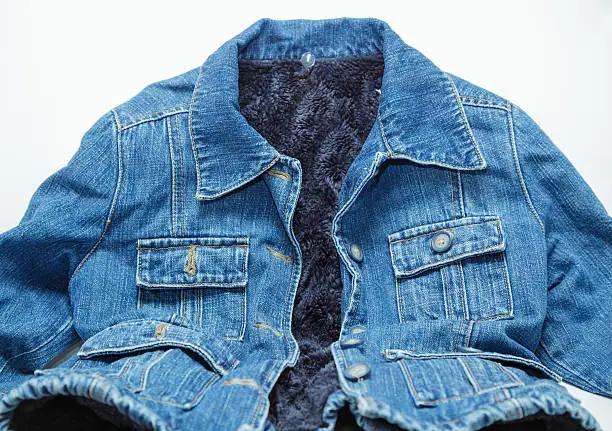 Photo of l fashionable blue jeans jacket lined with artificial dark blue fur