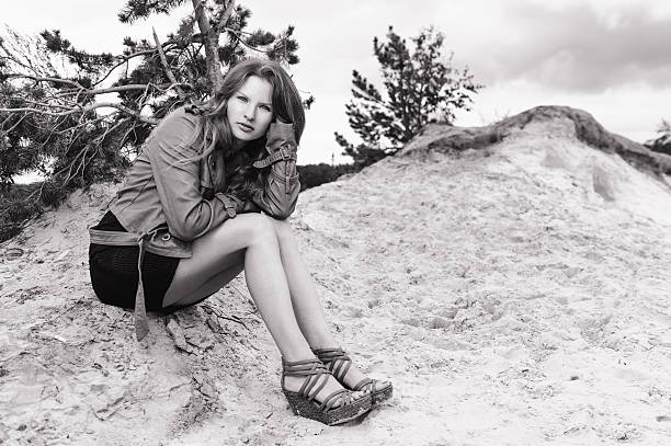 istock Girl sitting on the sand. BW 537185543