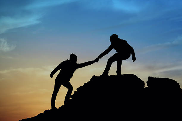 istock Silhouette of helping hand between two climber 537186035