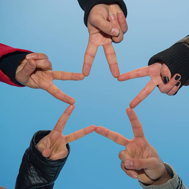 istock Five people engaged in hand with an asterisk 537186043