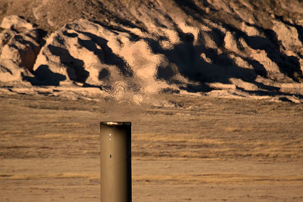 With the Pawnee Buttes in the background, combusted pollutants and heat are released into the air from hundreds of VOC vapor combustors across the area surrounding the Pawnee National Grasslands. Volatile organic compounds like hydrogen sulfide, gasses such as methane and other hazardous air pollutants are burned and then vented to the atmosphere. Surrounded by energy development, oil and gas storage tanks, flares and pollution emitting exhaust stacks stand along county road 127 and the road leading to the buttes. Recently the area has been greatly developed by the oil, gas and wind farm industries. Oil companies from around the nation frack the Niobrara oil shale on lands nearby and drill horizontally under the Pawnee National Grasslands. A light brown haze is now viewable over the area when viewed from the buttes overlook.