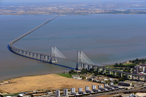 Lisbon, Portugal: Vasco da Gama bridge from the Air - cable-stayed bridge crossing of the Tagus River at Mar da Palha, with Lisbon (Expo 98/ Parque das Nações) in the foreground and Alcochete and Montijo in the background