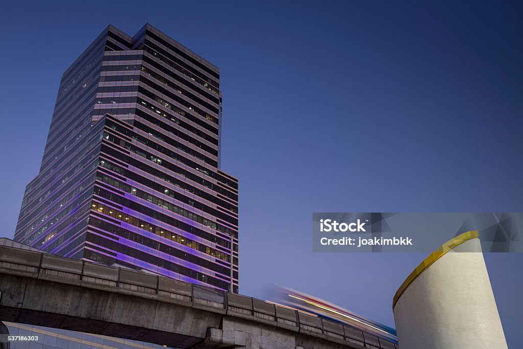 Bangkok skyscraper with aerial BTS in motion Bangkok skyscraper with aerial BTS flying by in slow motion. 2015 Stock Photo