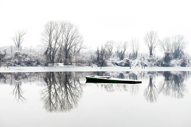 abandoned boat in a frozen lake winter in Novi Sad Serbia