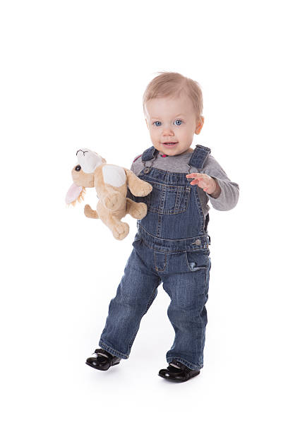 istock Baby girl in overalls 537190075