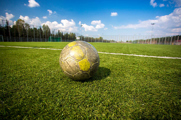 istock shabby soccer ball lying on artificial grass field 537190195