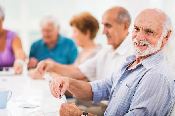 istock Happy senior man playing cards. 537191245