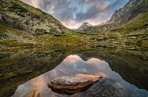 istock Mountain Lake with Rocks in Foreground at Sunset 537192304
