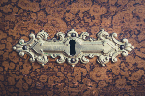beautiful vintage keyhole on wooden furniture macro