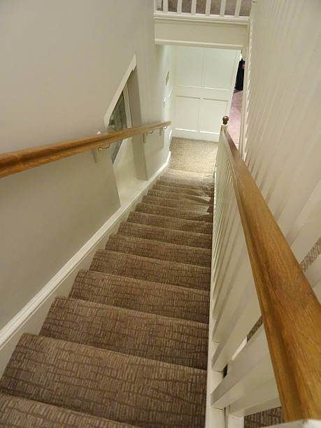istock Image of long staircase / stairs, patterned brown carpet, wooden handrail 537207495