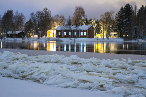 There is pack ice in the river. They are having good time on Christmas time in old cottage.