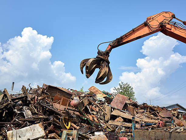 istock Gidraulic mechanical grabber moves scrap rusty metal heap 537208657