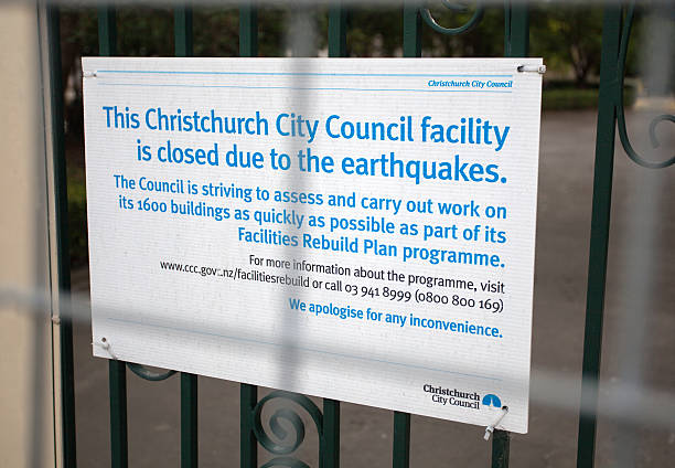 Christchurch Earthquake Damage Sign Christchurch, New Zealand - January 26, 2015: A sign in front of a damanged building discusses the challenges to rebuilding the city of Christchurch, New Zealand that was hit with a devastating earthquake in February 2011. The city still struggles to fix thousands of buildings with quake damage. christchurch earthquake stock pictures, royalty-free photos & images