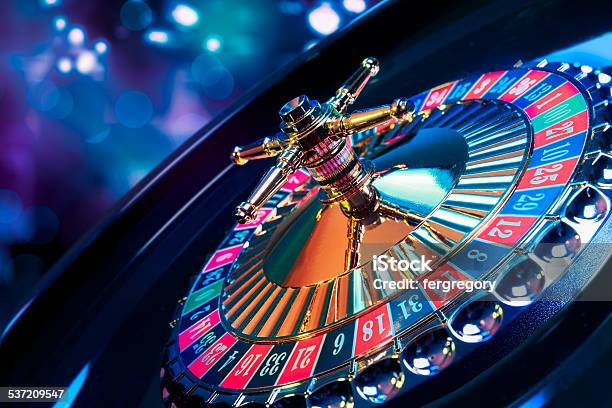 Roulette Wheel With A Bright And Colorful Background Stock Photo - Download Image Now